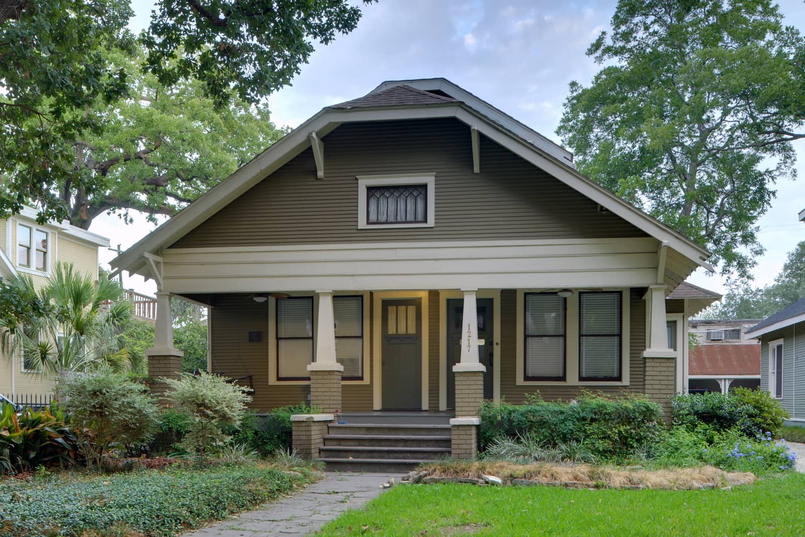 A Craftsman bungalow with a deep front porch and tapered columns on Harvard Street in Houston Heights
